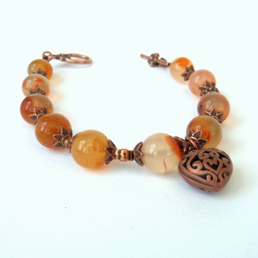 Orange carnelian and copper bracelet, with heart charm embelishment
