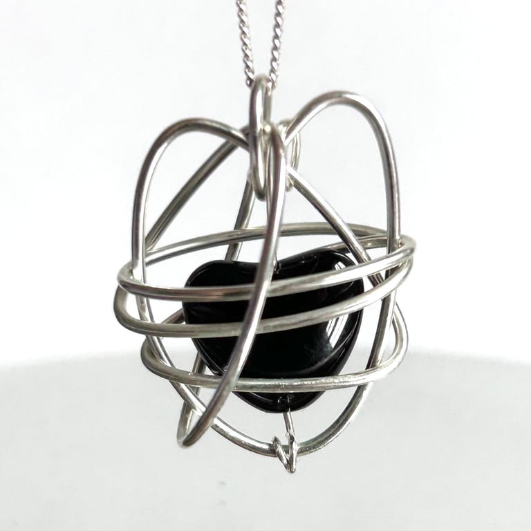 Heart shaped silver wire pendant with black onyx gemstone