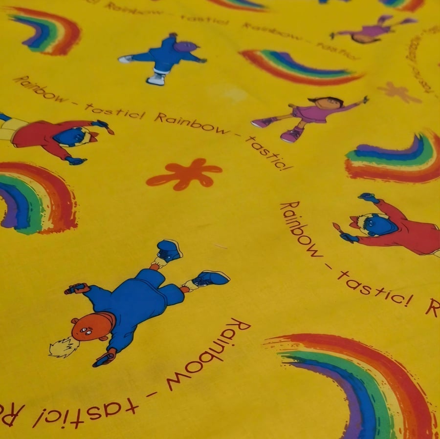 1 Metre Rainbow-Tastic Tweenies Children’s Cotton Fabric in Yellow 1.5m wide .
