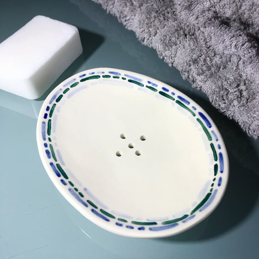 Ceramic handbuilt oval soap dish with blue dot dash pattern.