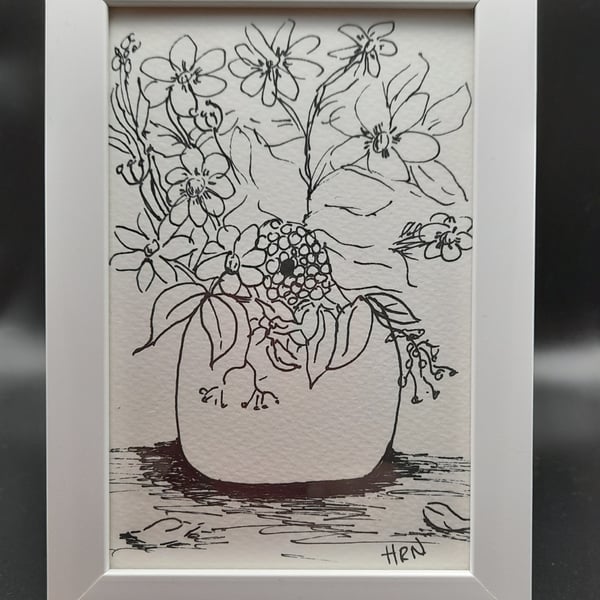 fine point pen drawing of flowers in a pot in a white frame ready to hang