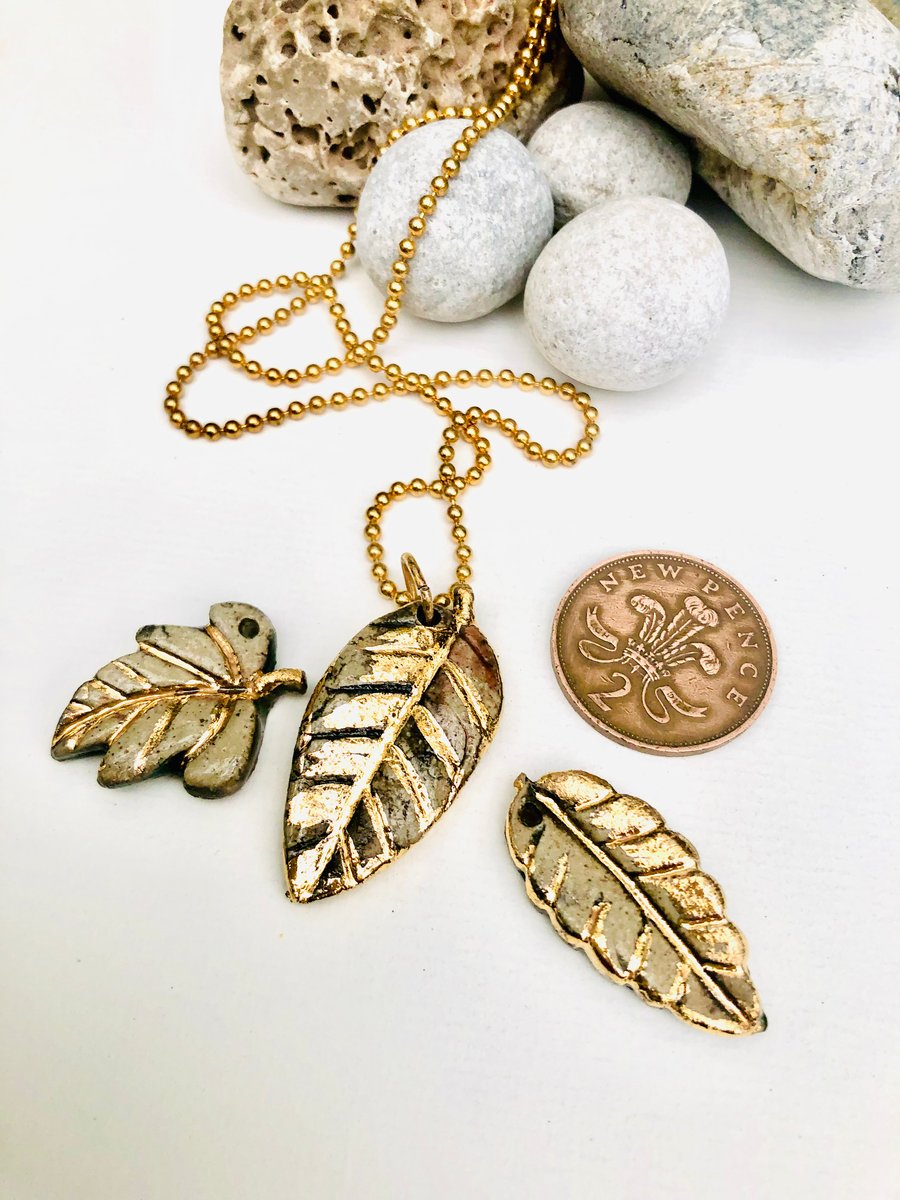 Ceramic leaf pendant with 24 gold lustre on 18 inch gold plated chain 