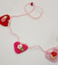 Crochet Hearts  and Flowers Mini Bunting in Pinks and Red - Image 2