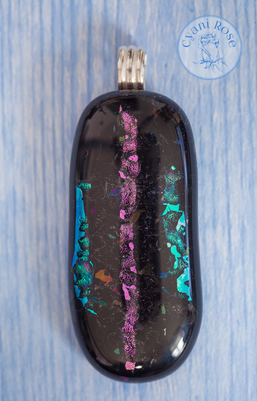 Black fused glass pendant with sparkle stripes in turquoise and pink