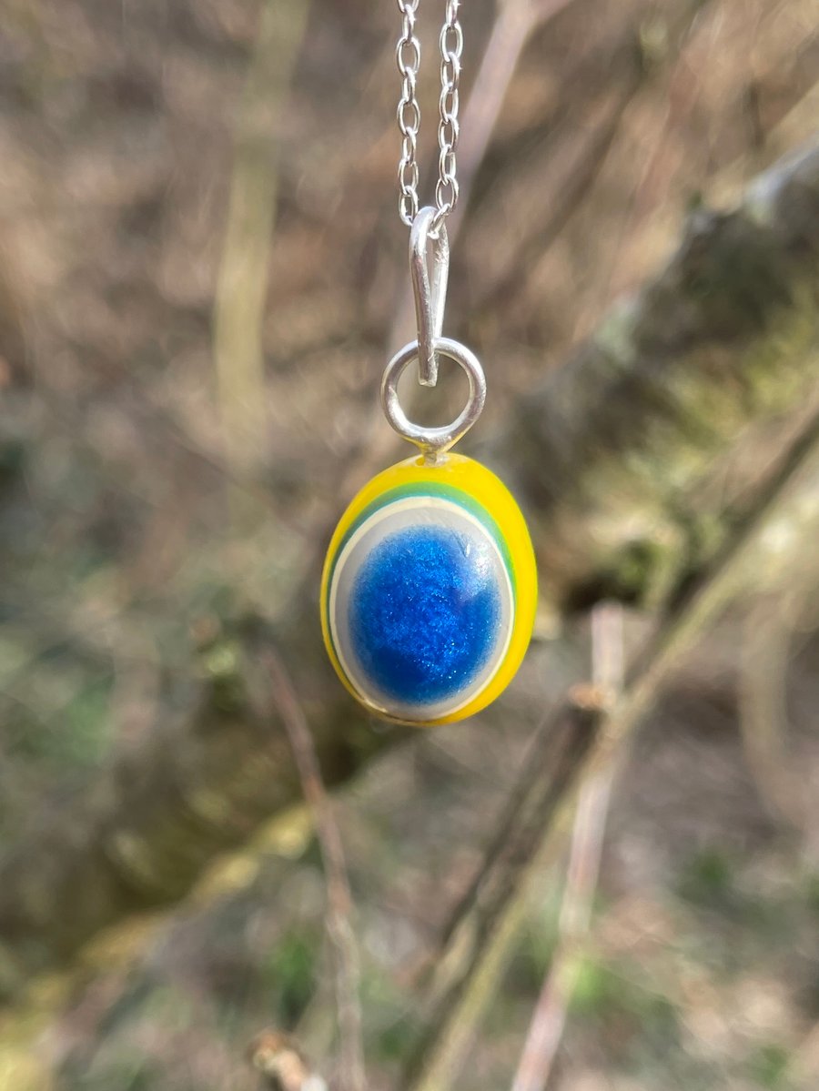 A Handcarved layered pendant in the colours of a Blue Tit