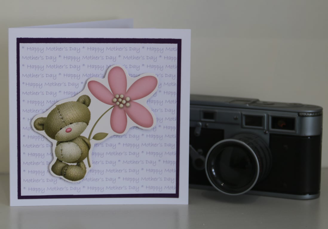 Mother's Day card: Teddy bear with a flower, on text background,  