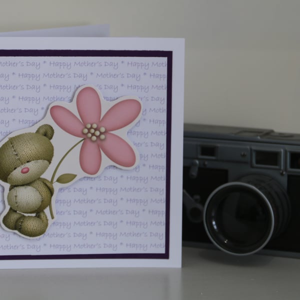 Mother's Day card: Teddy bear with a flower, on text background,  