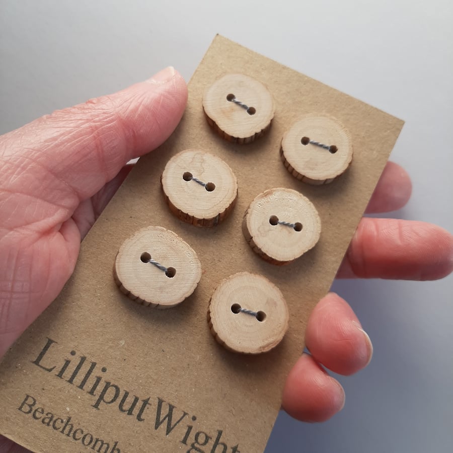 Six flat driftwood buttons