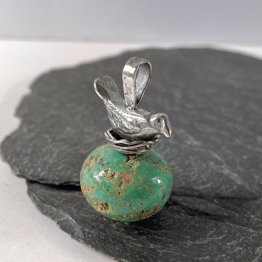 Sterling silver bird in nest and big turquoise bead pendant.