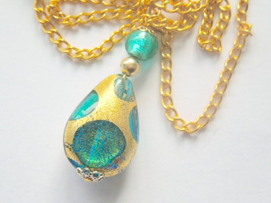 Murano glass gold and green pear drop pendant with gold chain.