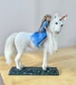 Needle felted unicorn with girl .