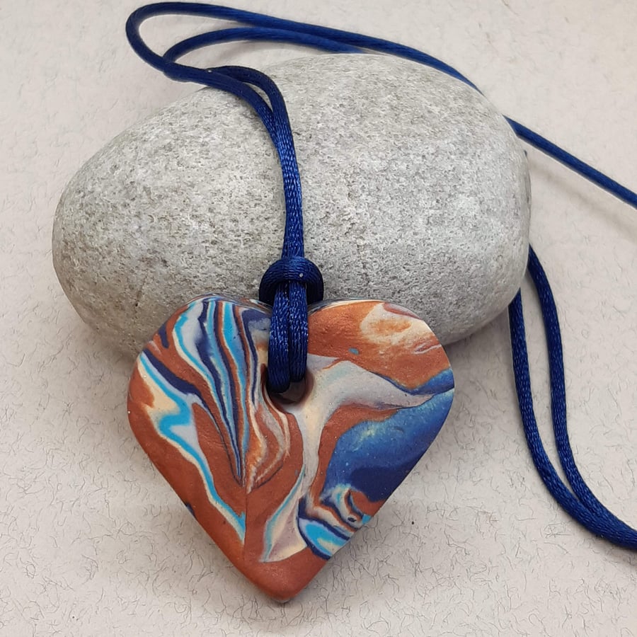 Navy and bronze heart shaped polymer clay pendant