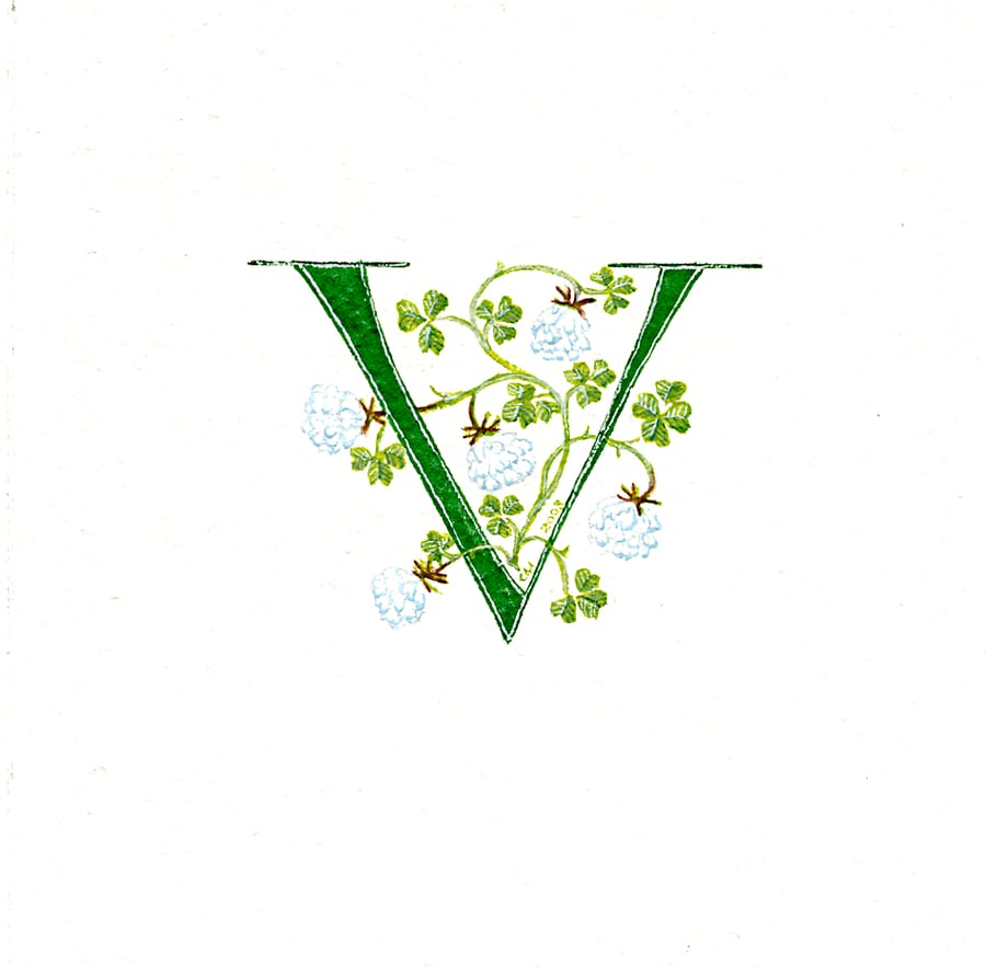 Initial letter 'V' handpainted in green with lucky white clover.