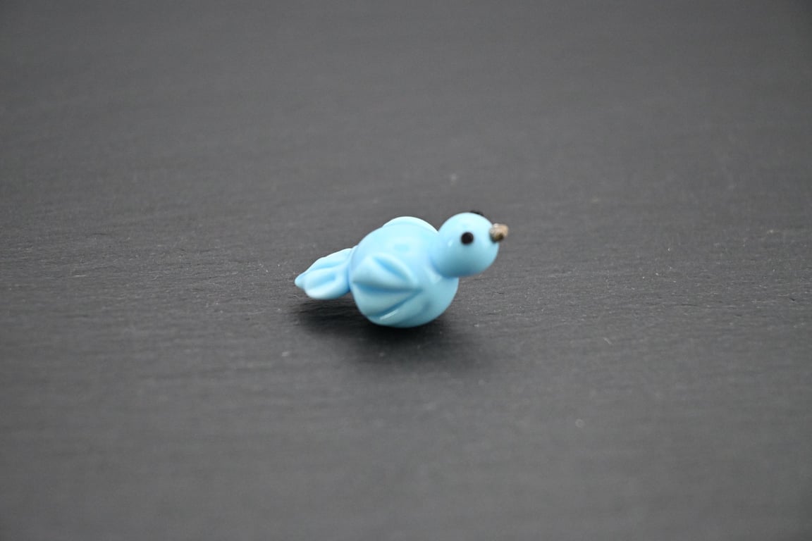 small glass blue bird
