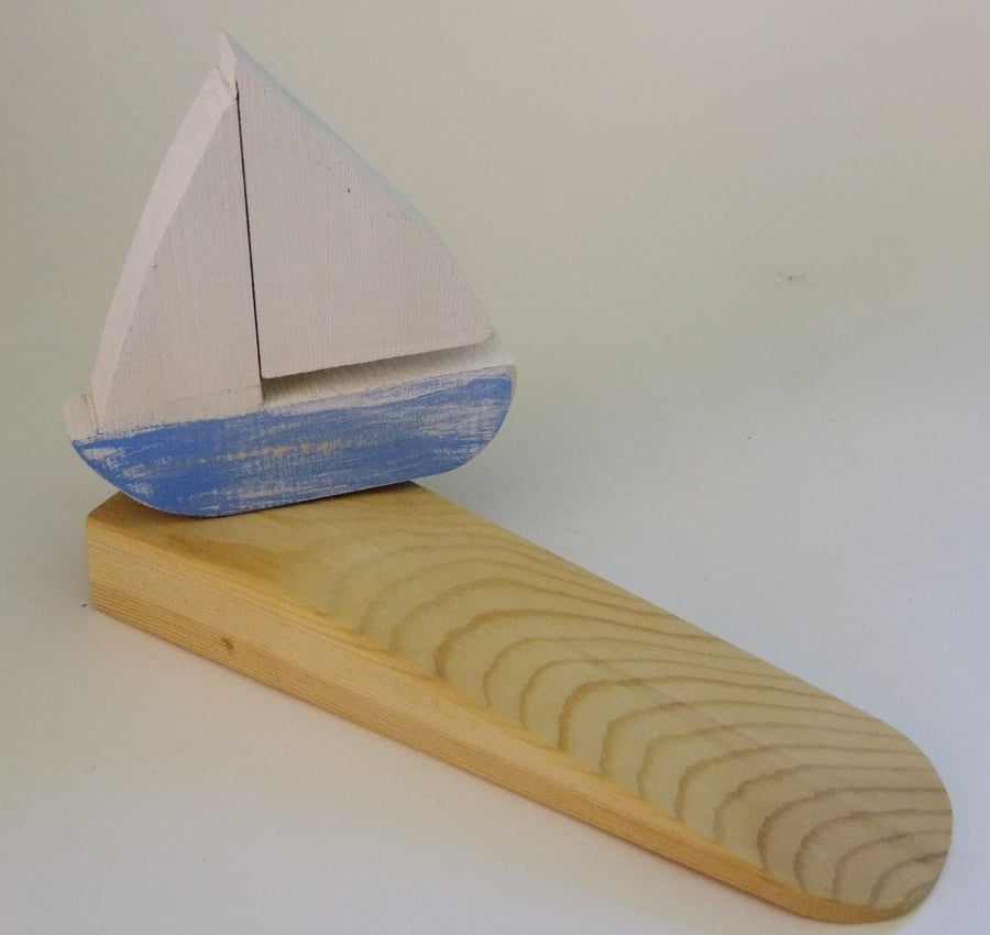 Door wedge with a sailing yatch or boat decoration, for that nautical theme.