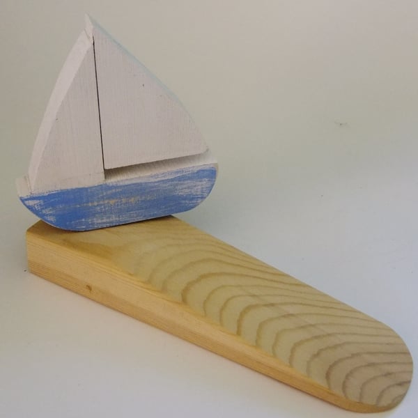 Door wedge with a sailing yatch or boat decoration, for that nautical theme.
