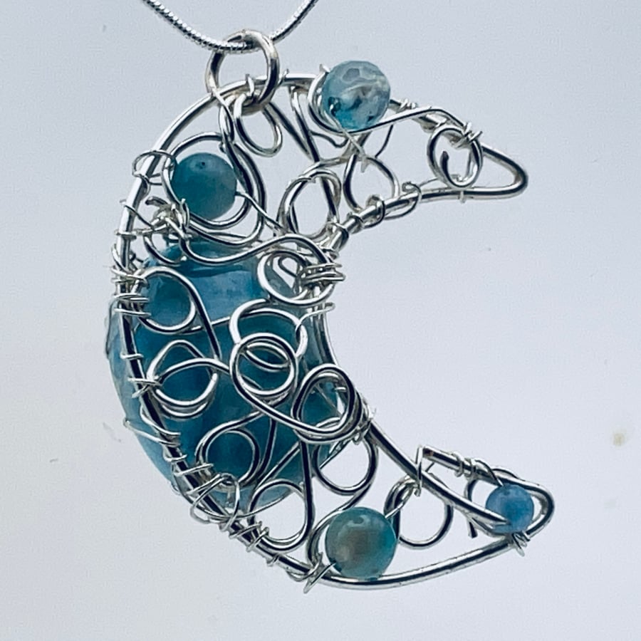 Blue gemstone and silver crescent moon pendant