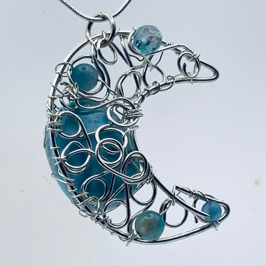 Blue gemstone and silver plated crescent moon pendant