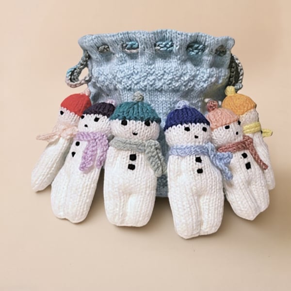 Handmade knitted snowmen in drawstring bag