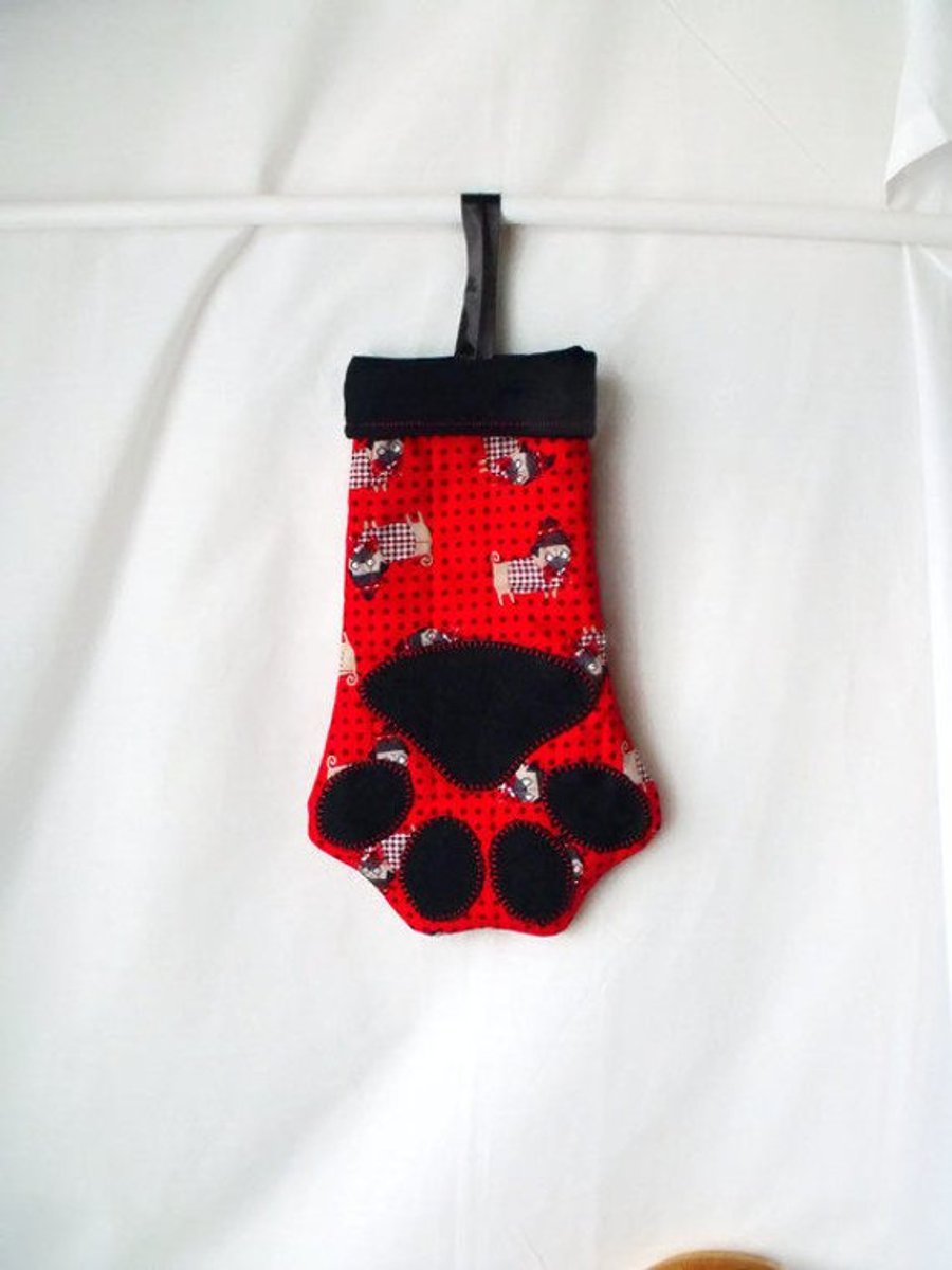 hanging paw shaped christmas stocking for small toys or treats, black lining