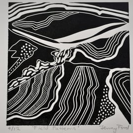 Black and white linocut of field patterns.