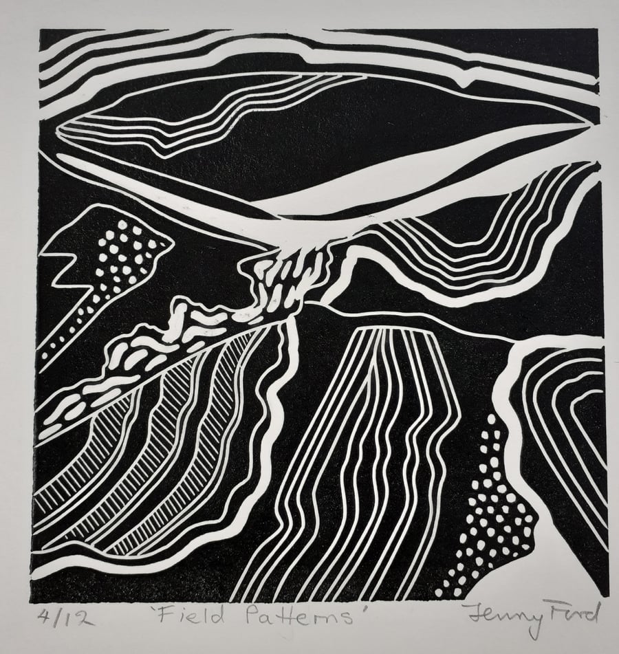Black and white linocut of field patterns.