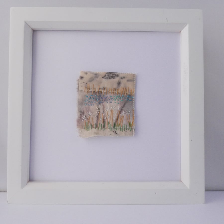 Framed handstitched Textile Landscape featuring white daisies,  