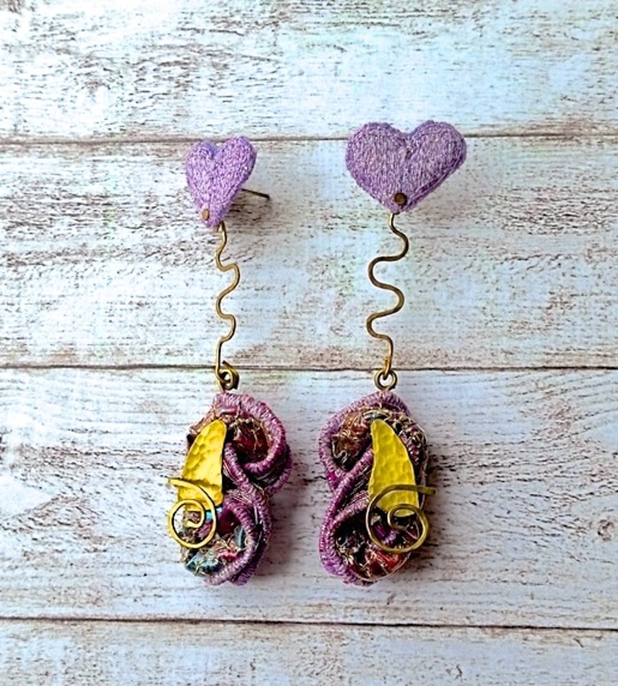 Embroidered sculptural sparkly dangle earrings.