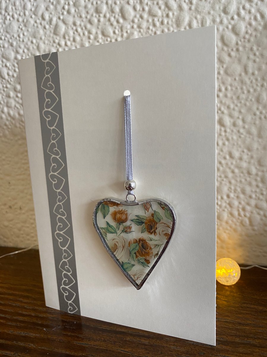 Greetings card with detachable decoration