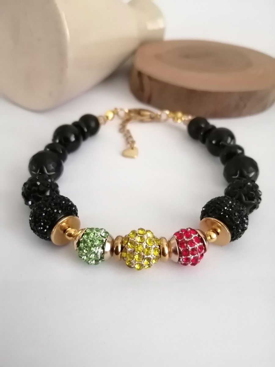 Red gold green & black beaded bracelet