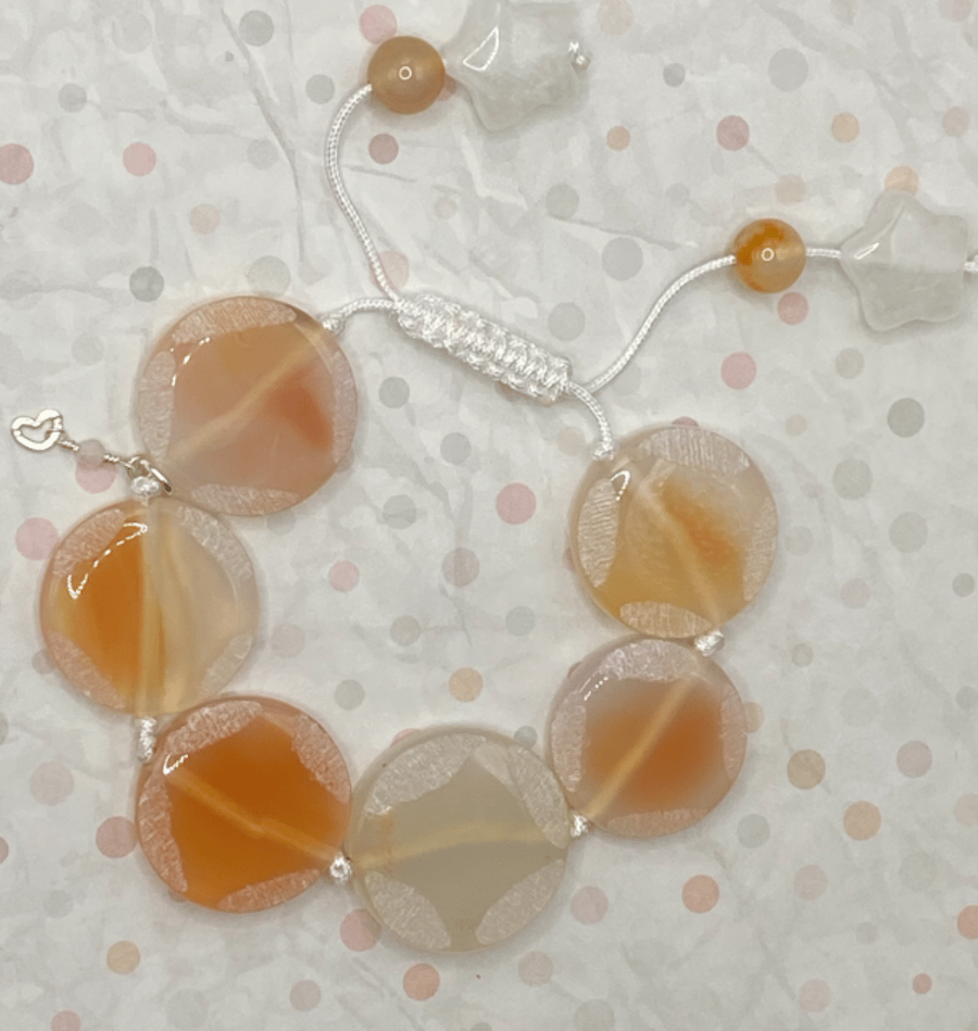 Knotted white cord bracelet with apricot agate stones