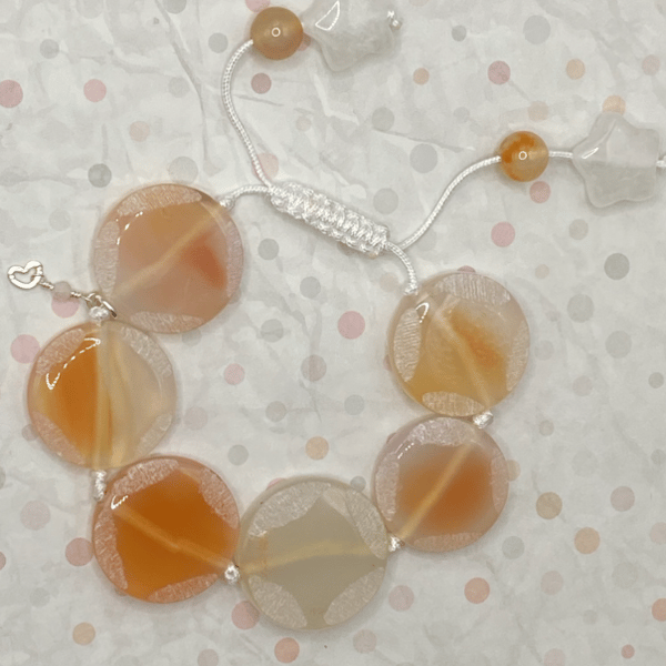 Knotted white cord bracelet with apricot agate stones