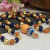 Mala necklace with gold hematite and orange and blue agate gemstones 