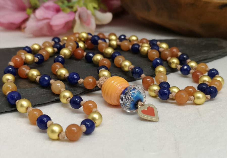 Mala necklace with gold hematite and orange and blue agate gemstones 