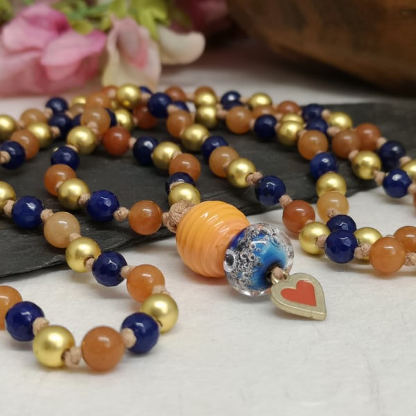 Mala necklace with gold hematite and orange and blue agate gemstones 