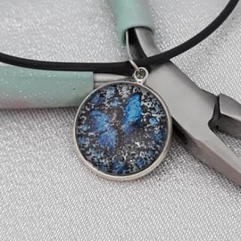 NL142  Blue butterfly picture pendant on cord necklace