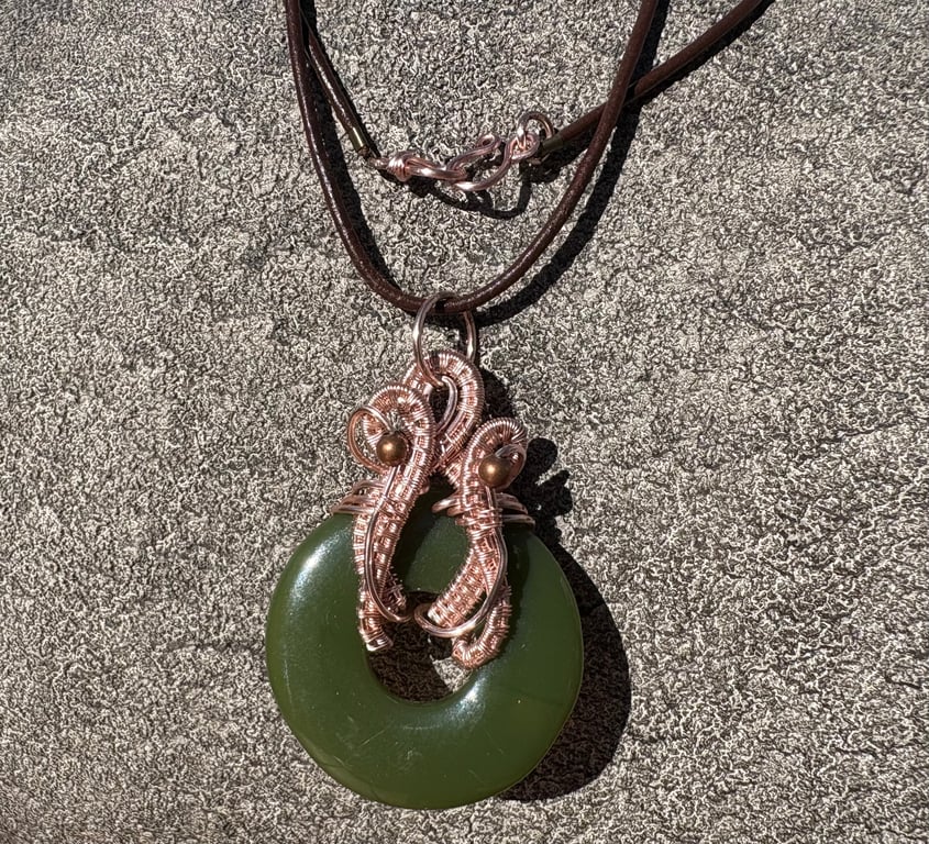 Wire wrapped jade green donut pendant