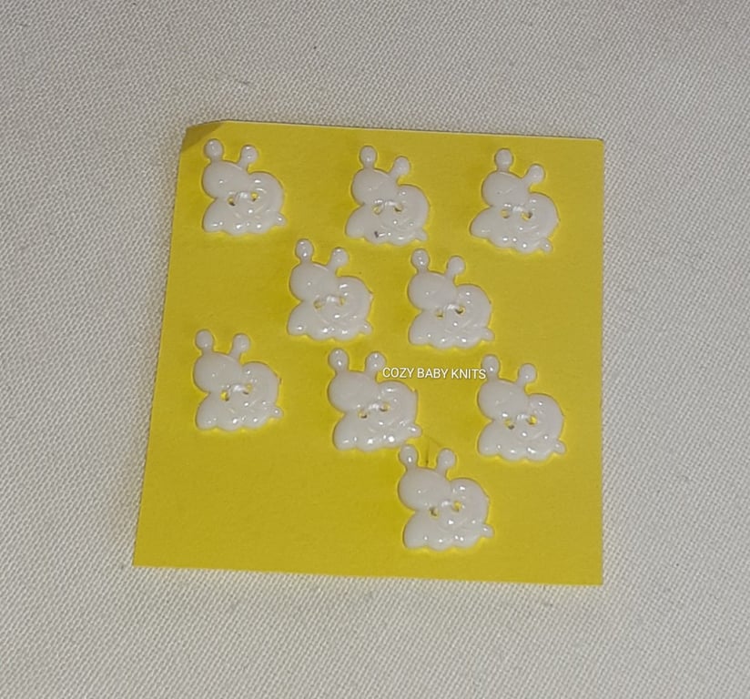 WHITE SNAIL SHAPED BUTTONS WITH TWO HOLES FOR ATTACHING 