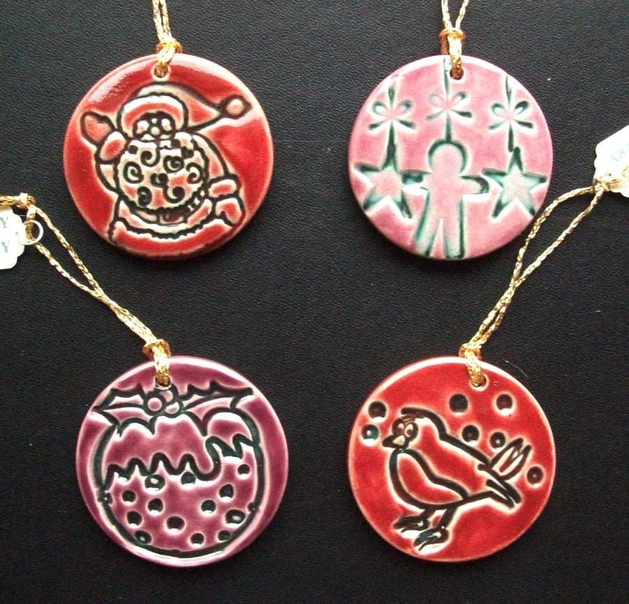 Set of four red, pink and plum ceramic Christmas decorations