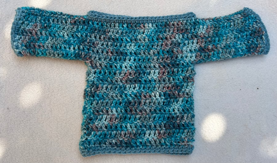 Sea blue jumper in soft acrylic yarn suitable for a new born baby.