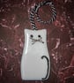 A fused glass cat light-catcher in white.