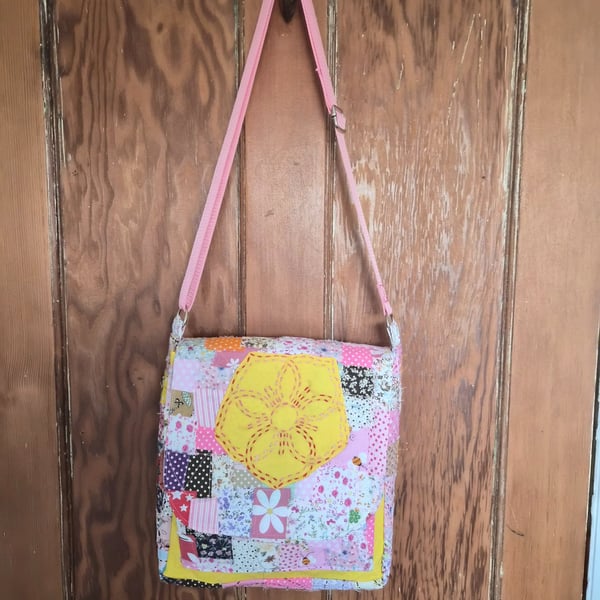 Quilted patchwork cross body bag with adjustable strap.