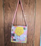 Quilted patchwork cross body bag with adjustable strap.