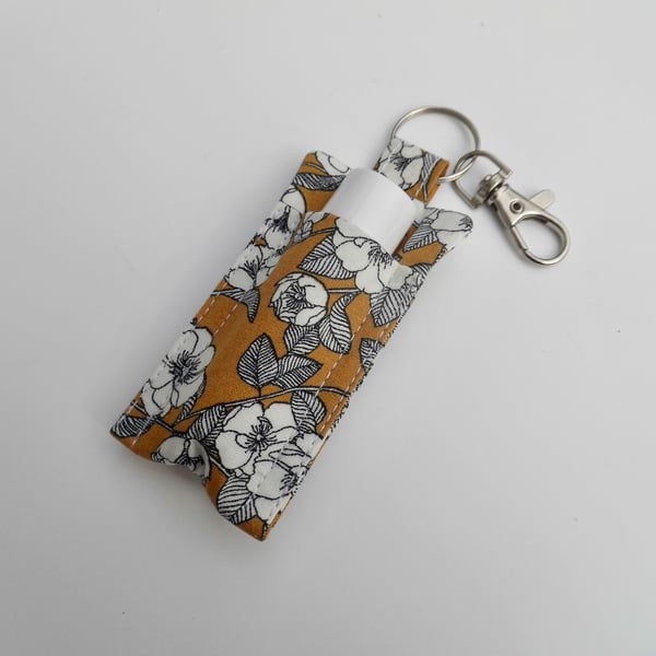 Key ring lip balm holder in mustard and black floral fabric keyring 