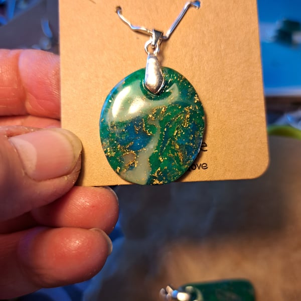 Dark green, blue, white and gold flecked  oval pendant