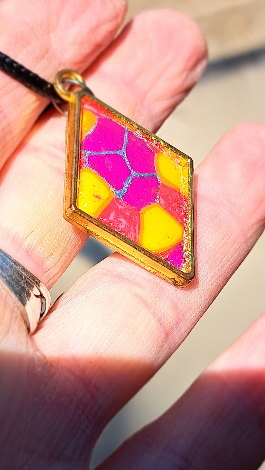 Diamond shape pendant on a rope necklace. blues and pinks