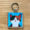 TORTOISESHELL CAT ON TURQUOISE BACKGROUND KEYRING