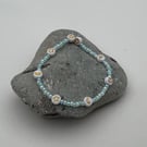 Beaded bracelet cute in blue and pearl with gold charms 