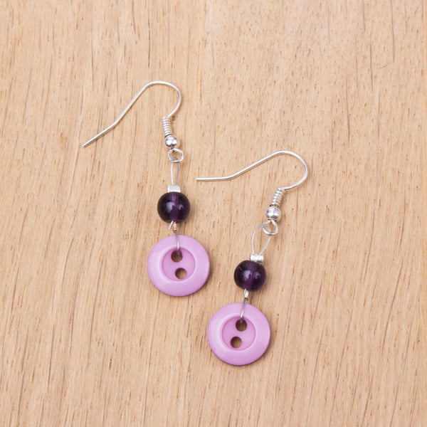 Pink button earrings with purple glass beads