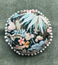 Round feature cushion in vintage leafy linen with pompoms - Image 10